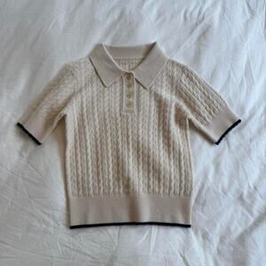 Cream wool polo shirt with black trim